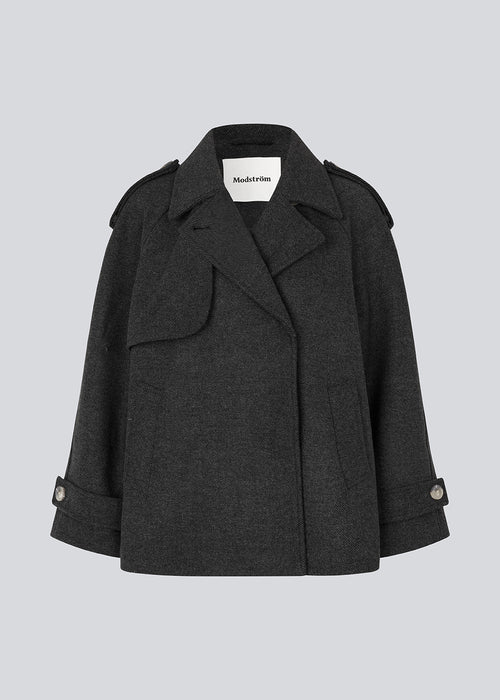 Double-breasted black wool coat with hidden buttons. EsmundMD jacket has classic coat details with raglan sleeves and a high yoke at the back.