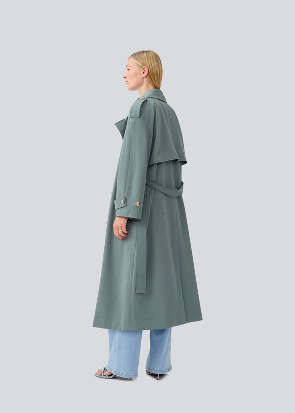 Oversized double-breasted trenchcoat with tie belt at the waist. EvieMD jacket has dropped shoulders and long, wide sleeves. Lined. 