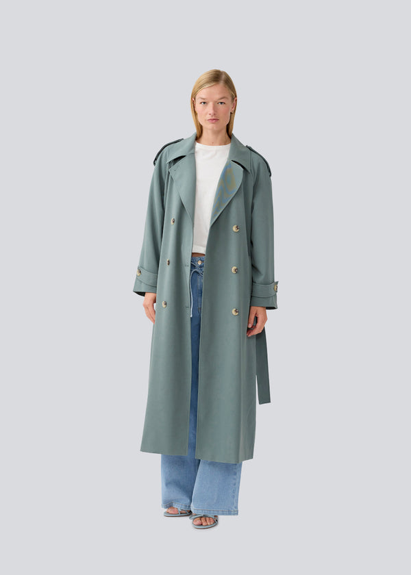 Oversized double-breasted trenchcoat with tie belt at the waist. EvieMD jacket has dropped shoulders and long, wide sleeves. Lined. 