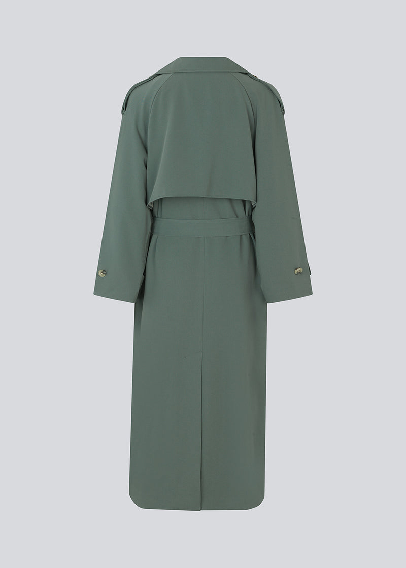 Oversized double-breasted trenchcoat with tie belt at the waist. EvieMD jacket has dropped shoulders and long, wide sleeves. Lined. 