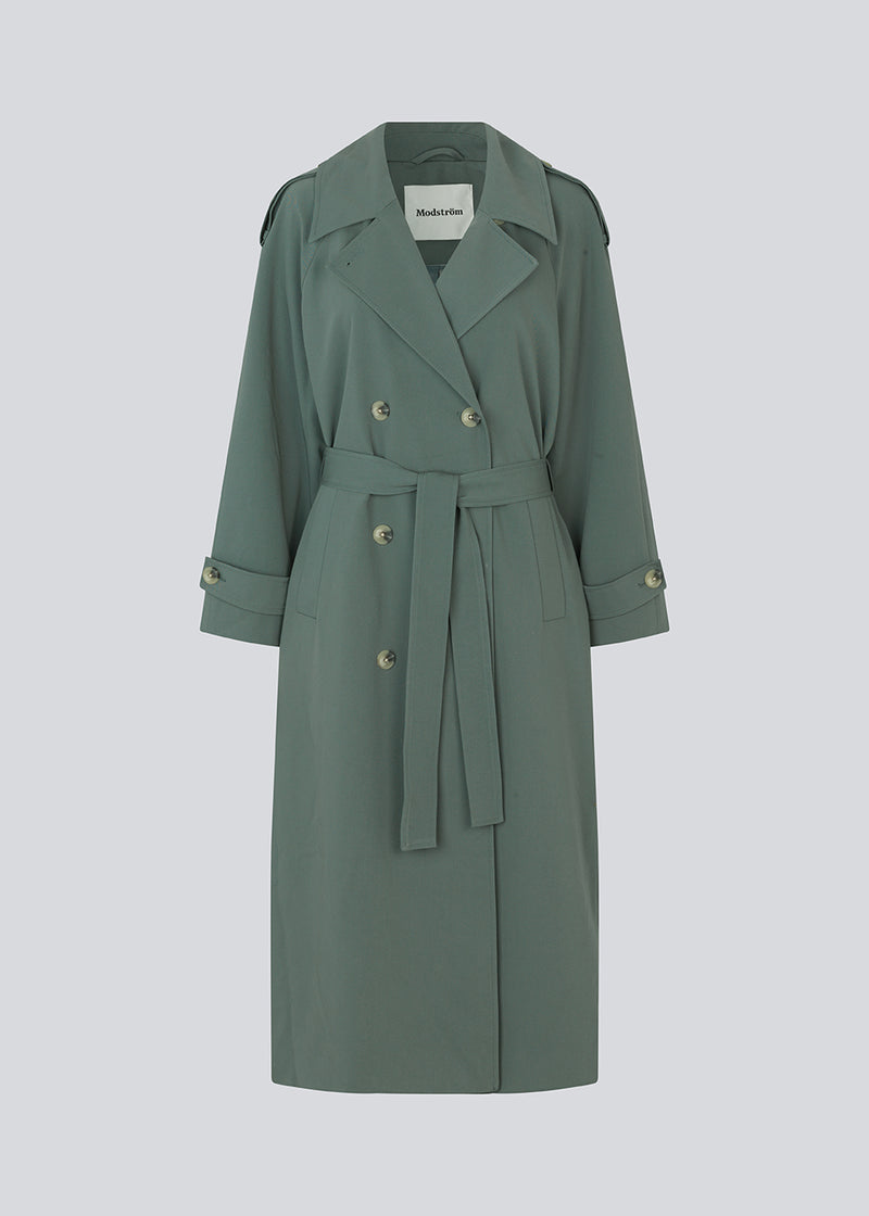 Oversized double-breasted trenchcoat with tie belt at the waist. EvieMD jacket has dropped shoulders and long, wide sleeves. Lined. 