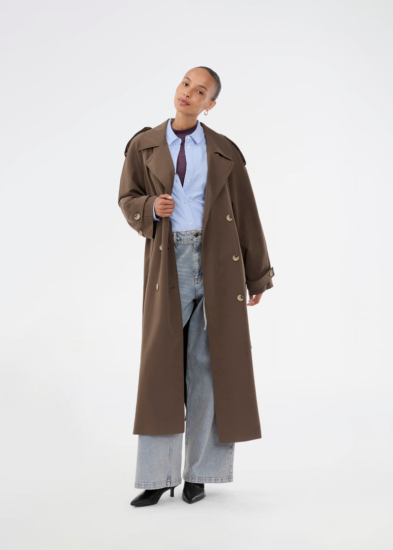 Oversized double-breasted trench coat in dark brown with tie belt at the waist. EvieMD jacket has dropped shoulders and long, wide sleeves. Lined.&nbsp;