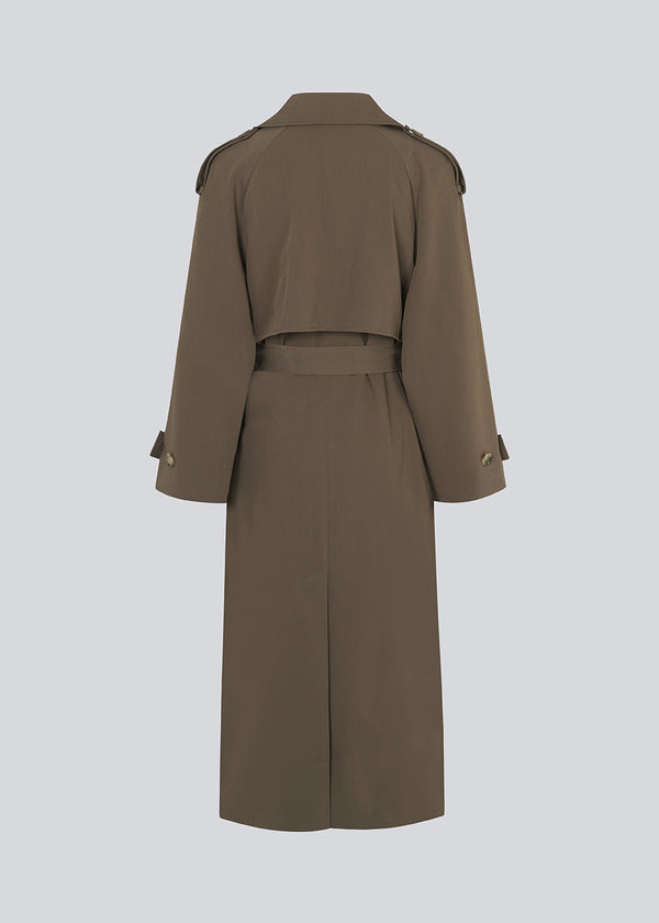 Oversized double-breasted trench coat in dark brown with tie belt at the waist. EvieMD jacket has dropped shoulders and long, wide sleeves. Lined. '