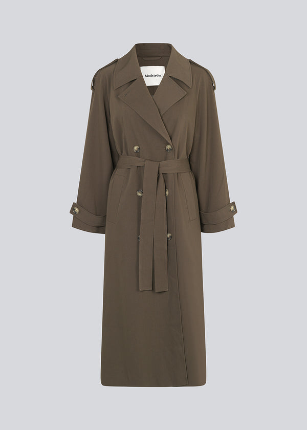 Oversized double-breasted trench coat in dark brown with tie belt at the waist. EvieMD jacket has dropped shoulders and long, wide sleeves. Lined. 