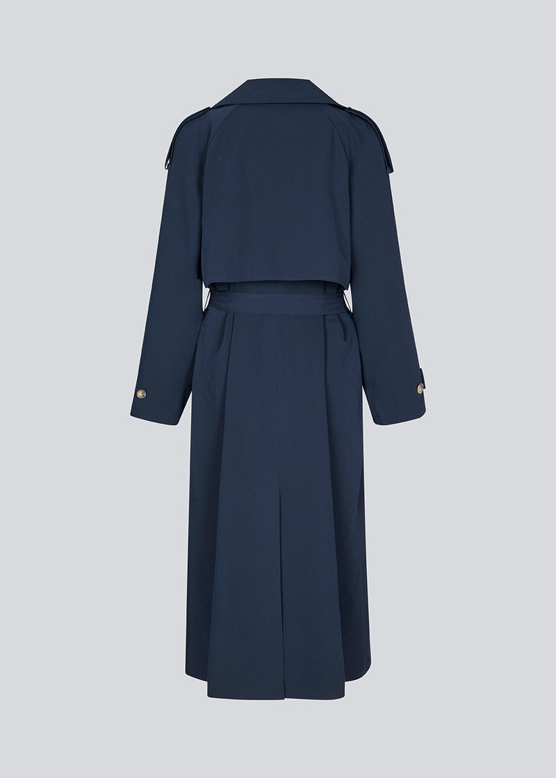 Oversized double-breasted trench coat with tie belt at the waist. EvieMD jacket has dropped shoulders and long, wide sleeves. Lined. The model is 175 cm and wears a size S/36.