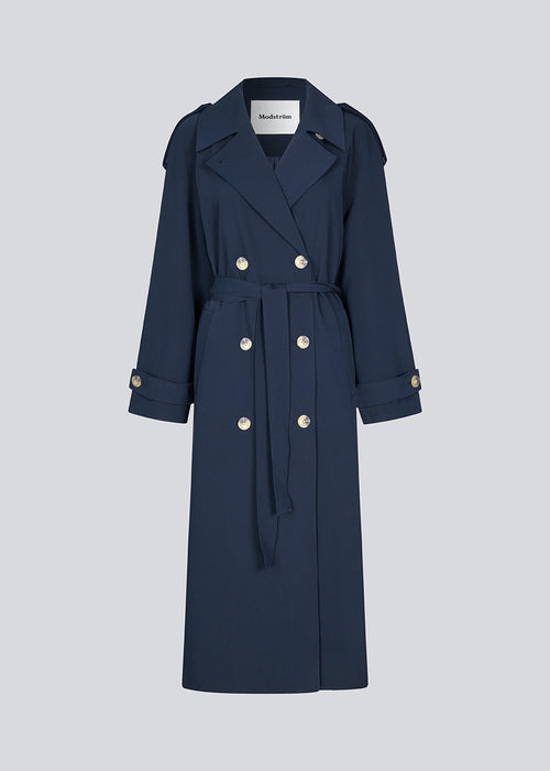 Oversized double-breasted trench coat with tie belt at the waist. EvieMD jacket has dropped shoulders and long, wide sleeves. Lined. The model is 175 cm and wears a size S/36.