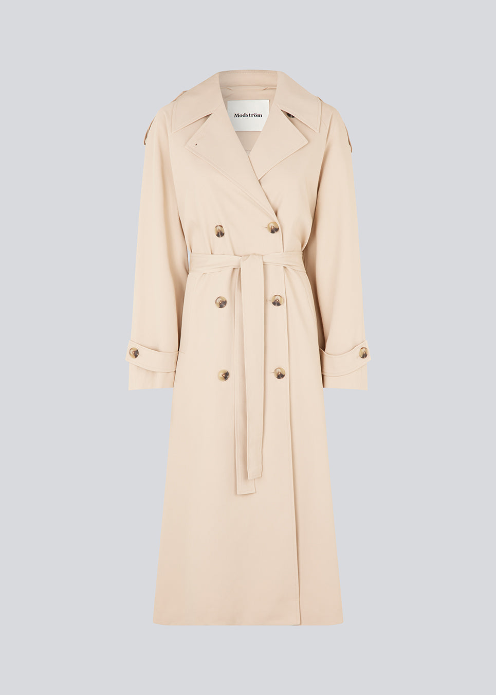 Oversized double-breasted trench coat in light beige with tie belt at the waist. EvieMD jacket has dropped shoulders and long, wide sleeves. Lined. The model is 175 cm and wears a size S/36.