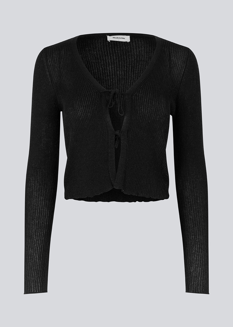 Black cardigan in an airy knit with a slightly see-through look. FaddieMD cardigan is a bit cropped, has long sleeves and tie band closure in front.