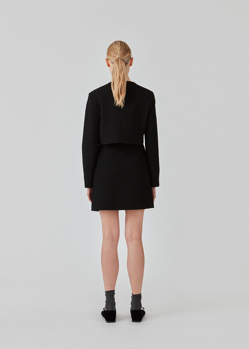 Short A-line dress in a structured material. FaiMD skirt has a high waist with a hidden zipper at the side. Lined. Style with matching blazer: FaiMD blazer.