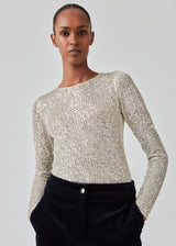 Long sleeved top fully decorated with sequins. FannieMD top has a tight fit with a round neck and long sleeves. The model is 175 cm and wears a size S/36.