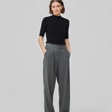 FanyaMD pants have a menswear-inspired look with straight, wide legs, a high waist with zip fly and button and elastication in back. Doubble pleat in front and side pockets. The model is 175 cm and wears a size S/36.