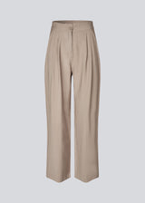 FanyaMD pants have a menswear-inspired look with straight, wide legs, a high waist with zip fly and button and elastication in back. Doubble pleat in front and side pockets. 