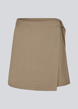 Short skirt in twill. FanyaMD skirt has a wrap detail and is closed with a belt buckle in the side.