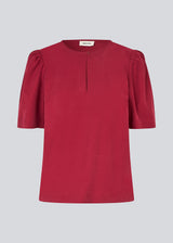 Top with short sleeves and a relaxed fit. FanyaMD SS top has an opening in front with a button closure.