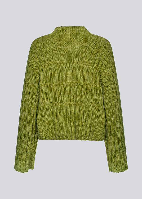 Green knit with dropped shoulders and long wide sleeves. FelipeMD t-neck has a high neck with ribbed trimmings on the neckline and hem of sleeves.