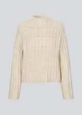Off white knit with dropped shoulders and long wide sleeves. FelipeMD t-neck has a high neck with ribbed trimmings on the neckline and hem of sleeves.&nbsp;