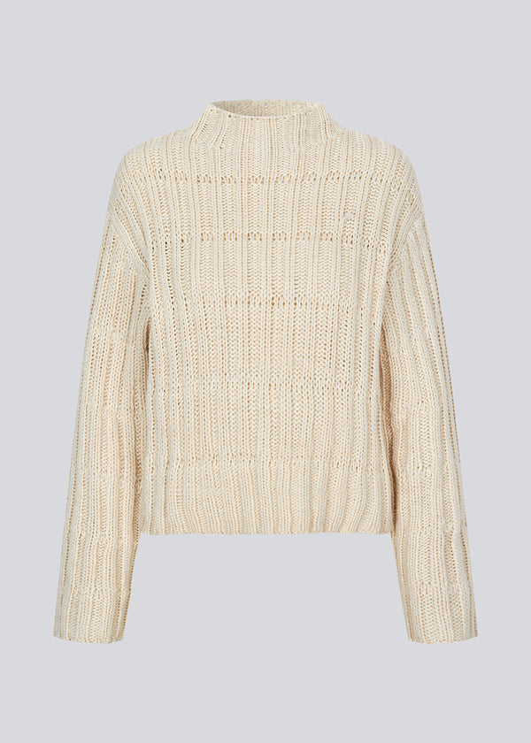 Off white knit with dropped shoulders and long wide sleeves. FelipeMD t-neck has a high neck with ribbed trimmings on the neckline and hem of sleeves.&nbsp;