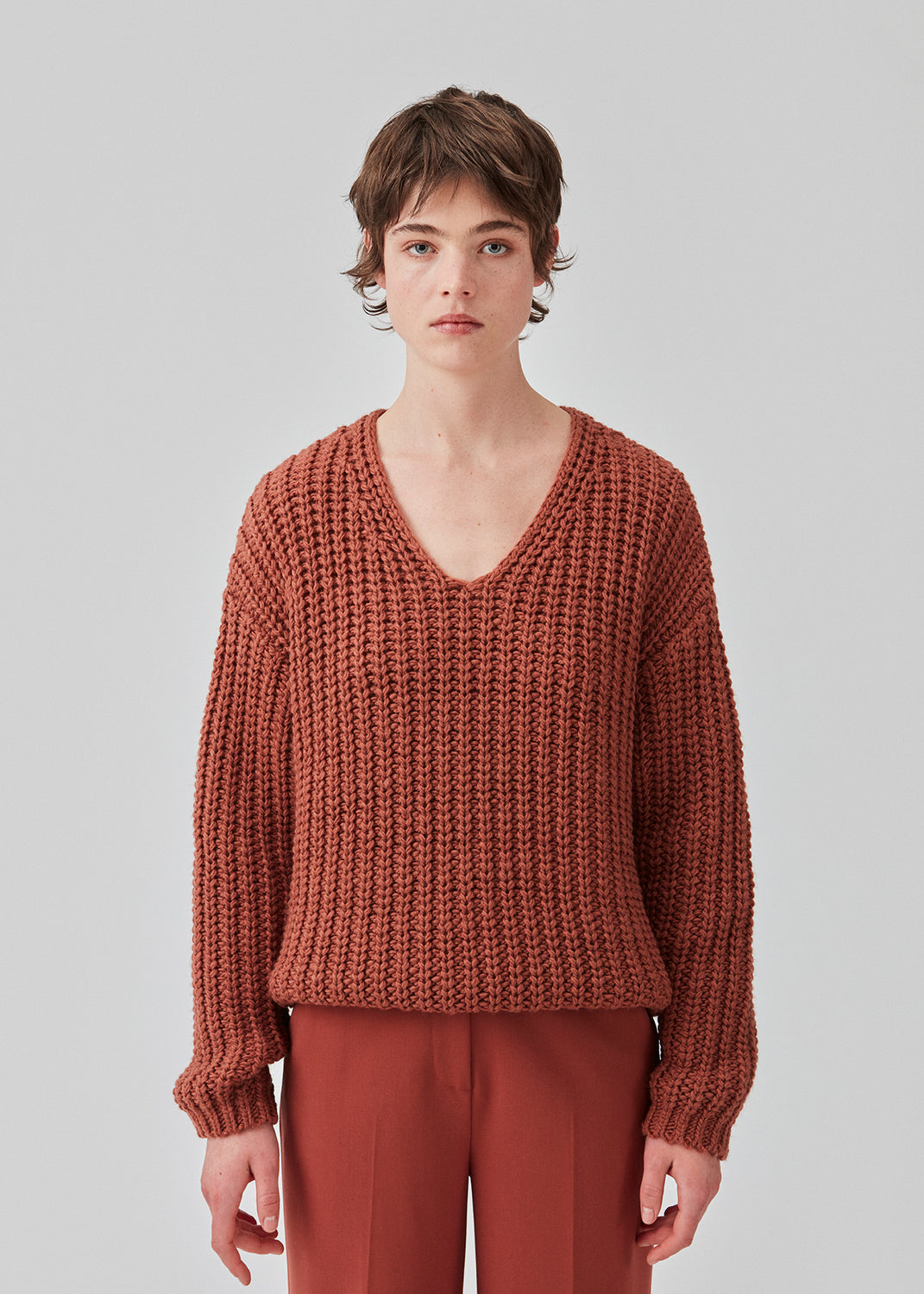 Chunky knit with a relaxed shape in the color maple. FelipeMD v-neck has a v-neckline, long sleeves and ribbed trimmings at the hems. The model is 175 cm and wears a size S/36.