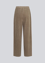 Corduroy pants in beige with long, wide legs and a high waist with zip fly and button, and elastic on the back. FikaMD pants are lined. 