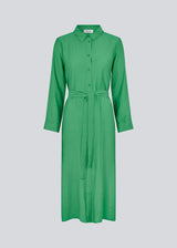 Midi dress in green in woven quality with collar, buttons in front, detachable tie belt at the waist and a slit at each side. Long sleeves with cuff. The model is 175 cm and wears a size S/36.