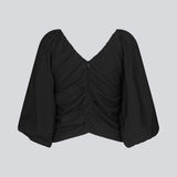 Long sleeved top in black in woven quality with long, voluminous sleeves. FisherMD top has a v-neckline in front and back with ruched seams, adding a drapy effect.