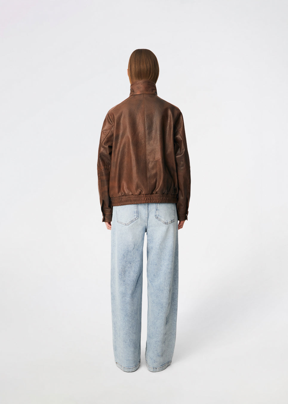 Forestmd jacket is designed in a relaxed silhouette with a high stand collar, concealed asymmetrical closure, and elasticated hem for a cool bomber-inspired look. The textured leather-look finish adds character, while the oversized fit makes it a versatile outerwear piece that effortlessly elevates both casual and dressed-up outfits.

