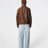 Forestmd jacket is designed in a relaxed silhouette with a high stand collar, concealed asymmetrical closure, and elasticated hem for a cool bomber-inspired look. The textured leather-look finish adds character, while the oversized fit makes it a versatile outerwear piece that effortlessly elevates both casual and dressed-up outfits.
