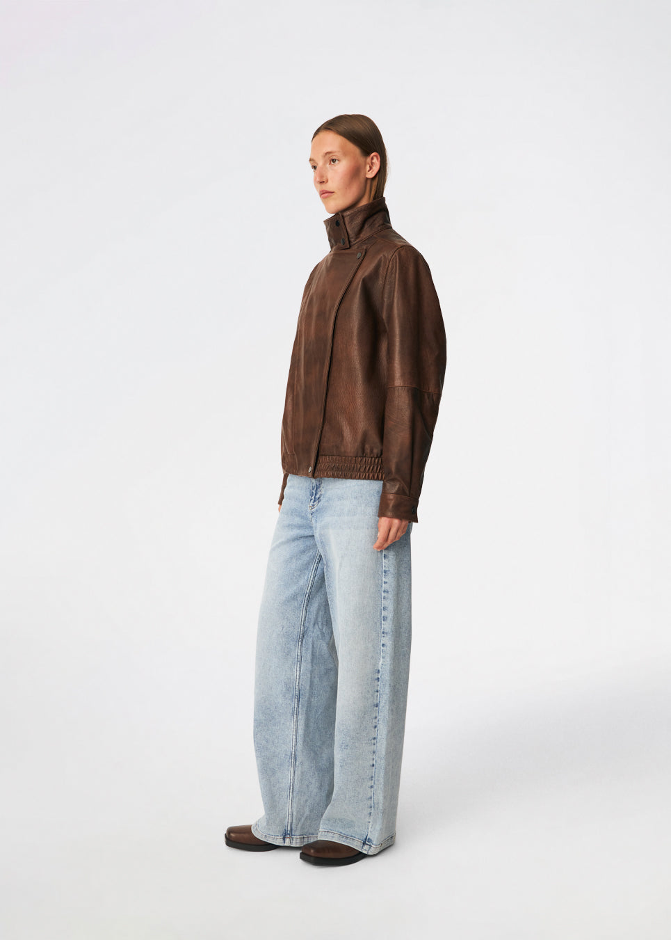 Forestmd jacket is designed in a relaxed silhouette with a high stand collar, concealed asymmetrical closure, and elasticated hem for a cool bomber-inspired look. The textured leather-look finish adds character, while the oversized fit makes it a versatile outerwear piece that effortlessly elevates both casual and dressed-up outfits.
