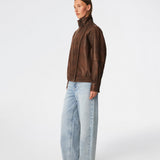 Forestmd jacket is designed in a relaxed silhouette with a high stand collar, concealed asymmetrical closure, and elasticated hem for a cool bomber-inspired look. The textured leather-look finish adds character, while the oversized fit makes it a versatile outerwear piece that effortlessly elevates both casual and dressed-up outfits.
