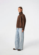 Forestmd jacket is designed in a relaxed silhouette with a high stand collar, concealed asymmetrical closure, and elasticated hem for a cool bomber-inspired look. The textured leather-look finish adds character, while the oversized fit makes it a versatile outerwear piece that effortlessly elevates both casual and dressed-up outfits.
