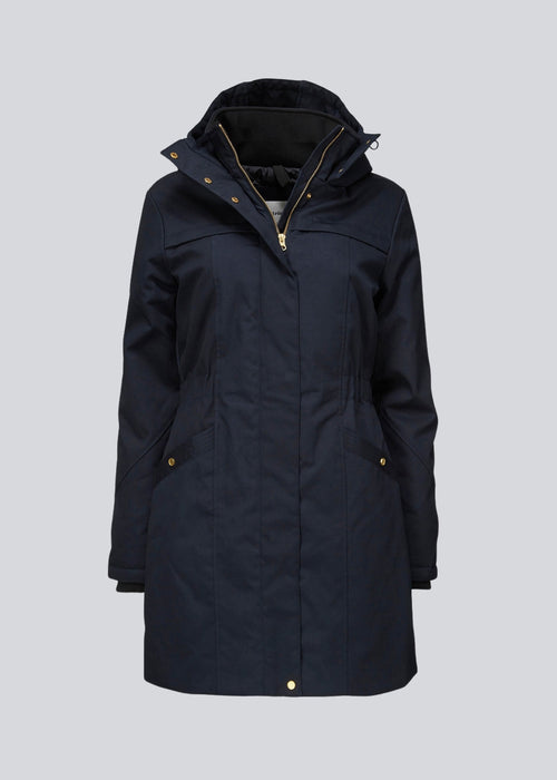 Frida gold trim in navy noir is knee-length and has invisble button/zipper closure. The jacket has a tight fit, which gives a feminine look. The padding is M3 Thinsulate, which is recognized for it's high insulation ability and is therefore the perfect choice.