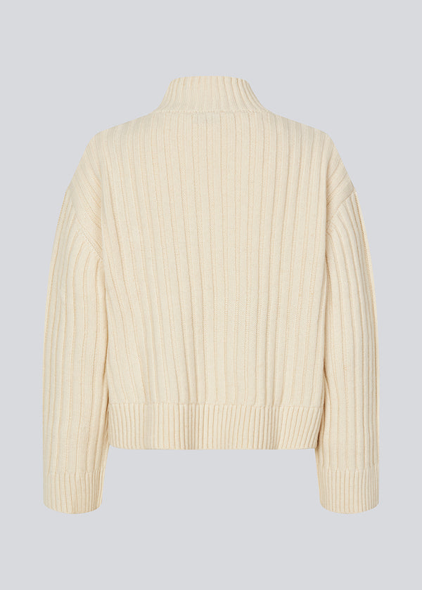 Off white rib knitted jumper with a high neck and a relaxed fit. FultonMD rib t-neck has dropped shoulders and long wide sleeves.