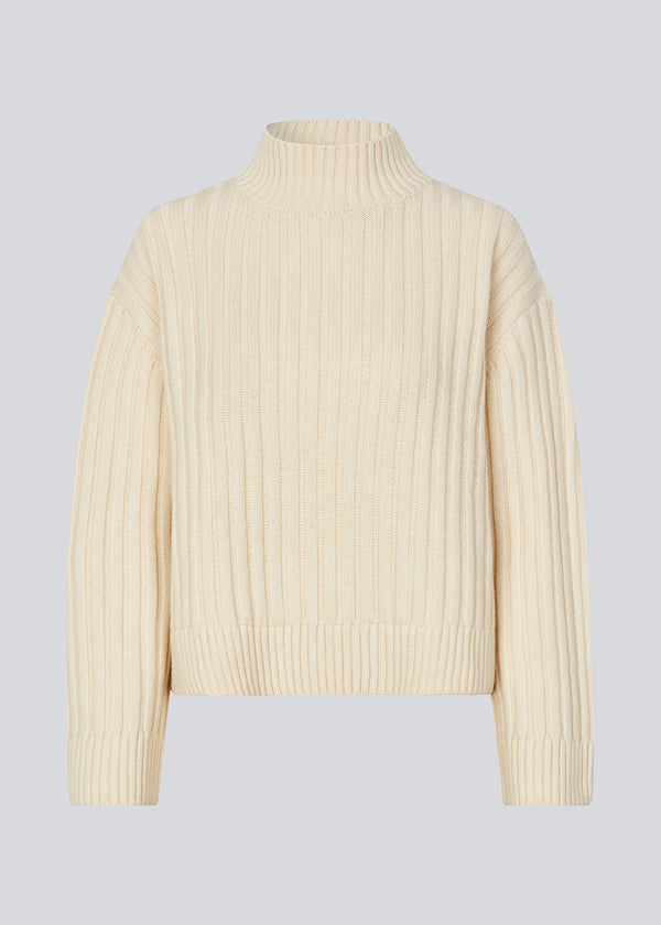 Off white rib knitted jumper with a high neck and a relaxed fit. FultonMD rib t-neck has dropped shoulders and long wide sleeves.