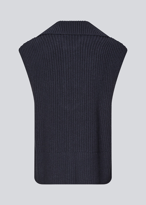 Sleeveless knit vest in a navy color made from a heavy woolen quality with a roomy fit. FultonMD vest has a half-zip front and a wide collar.