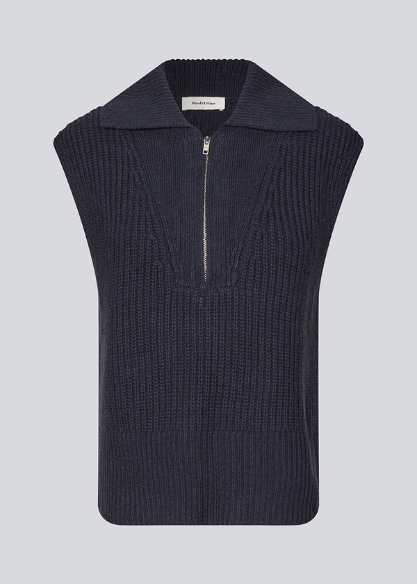 Sleeveless knit vest in a navy color made from a heavy woolen quality with a roomy fit. FultonMD vest has a half-zip front and a wide collar.