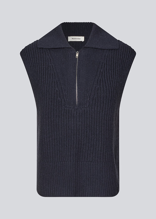 Sleeveless knit vest in a navy color made from a heavy woolen quality with a roomy fit. FultonMD vest has a half-zip front and a wide collar.