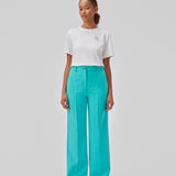 Gale pants in turquoise have a classic design. The pants have straight, wide legs with press folds, which creates an elegant look. The model is 175 cm and wears a size S/36.  Shop matching blazer: Gale blazer.