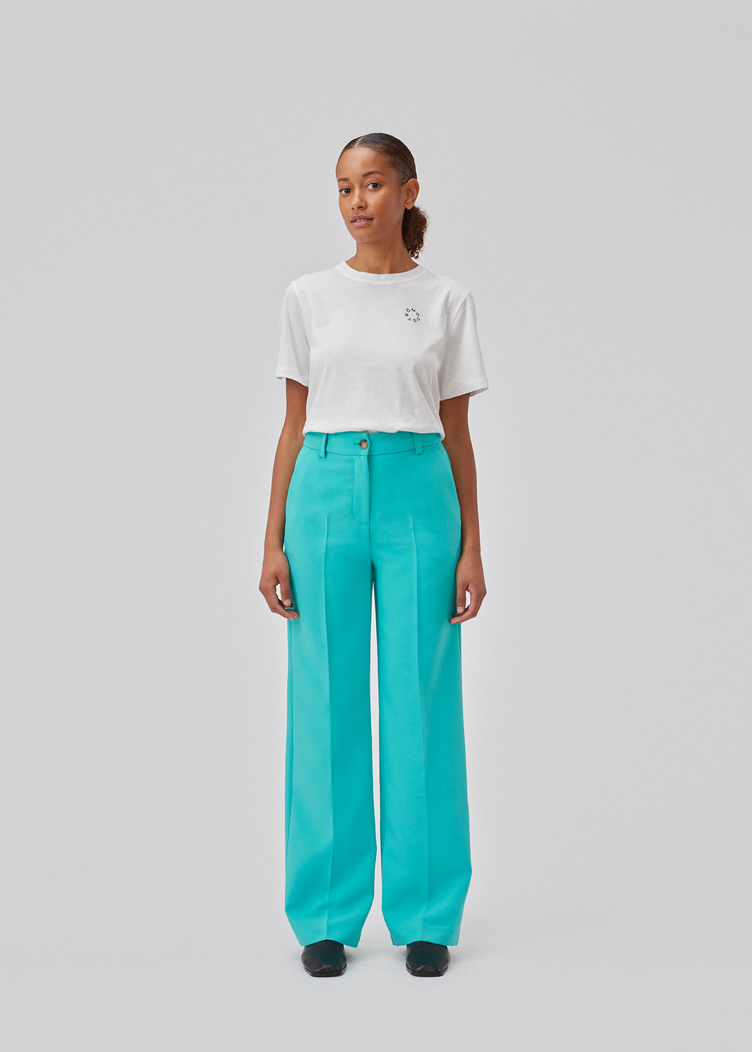 Gale pants in turquoise have a classic design. The pants have straight, wide legs with press folds, which creates an elegant look. The model is 175 cm and wears a size S/36.  Shop matching blazer: Gale blazer.