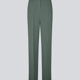 Gale pants in dark green have a classic design. The pants have straight, wide legs with pressfolds, which create an elegant look. The model is 175 cm and wears a size S/36.