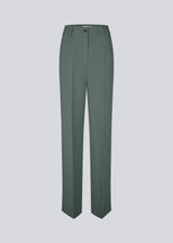 Gale pants in dark green have a classic design. The pants have straight, wide legs with pressfolds, which create an elegant look. The model is 175 cm and wears a size S/36.