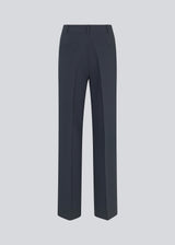 Gale pants in midnight blue have a classic design. The pants have straight, wide legs with press folds, which creates an elegant look. The model is 177 cm and wears a size S/36.  Style the pants with matching blazer in the same color: Gale blazer.