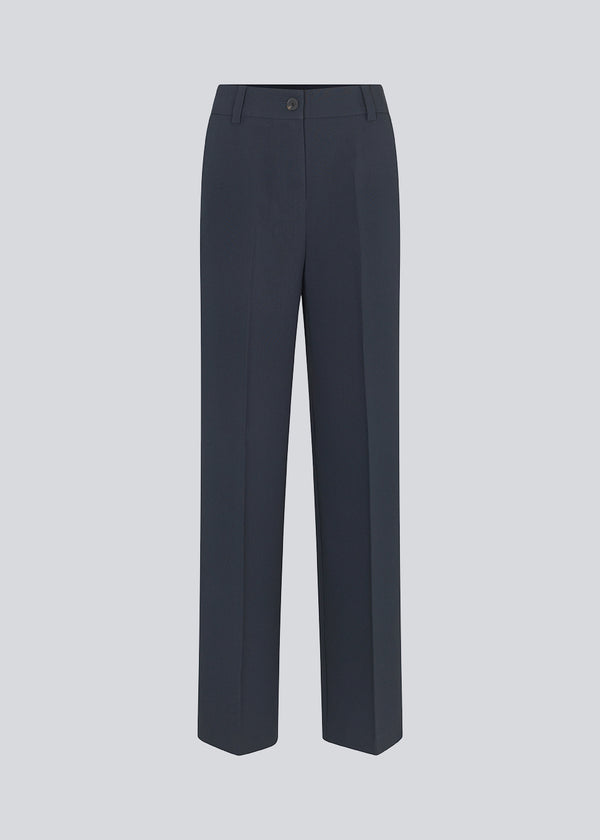 Gale pants in midnight blue have a classic design. The pants have straight, wide legs with press folds, which creates an elegant look. The model is 177 cm and wears a size S/36.  Style the pants with matching blazer in the same color: Gale blazer.