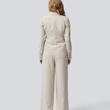 GaleMD 2 short blazer features the classic Gale design but in a lighter quality. The blazer is fitted, slightly cropped, and has a button closure and two pockets in front. The blazer is light cream.