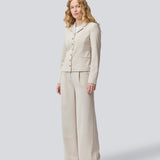 GaleMD 2 short blazer features the classic Gale design but in a lighter quality. The blazer is fitted, slightly cropped, and has a button closure and two pockets in front. The blazer is light cream.