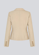 GaleMD 2 short blazer features the classic Gale design but in a lighter quality. The blazer is fitted, slightly cropped, and has a button closure and two pockets in front. The blazer is light cream.
