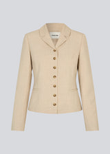 GaleMD 2 short blazer features the classic Gale design but in a lighter quality. The blazer is fitted, slightly cropped, and has a button closure and two pockets in front. The blazer is light cream.