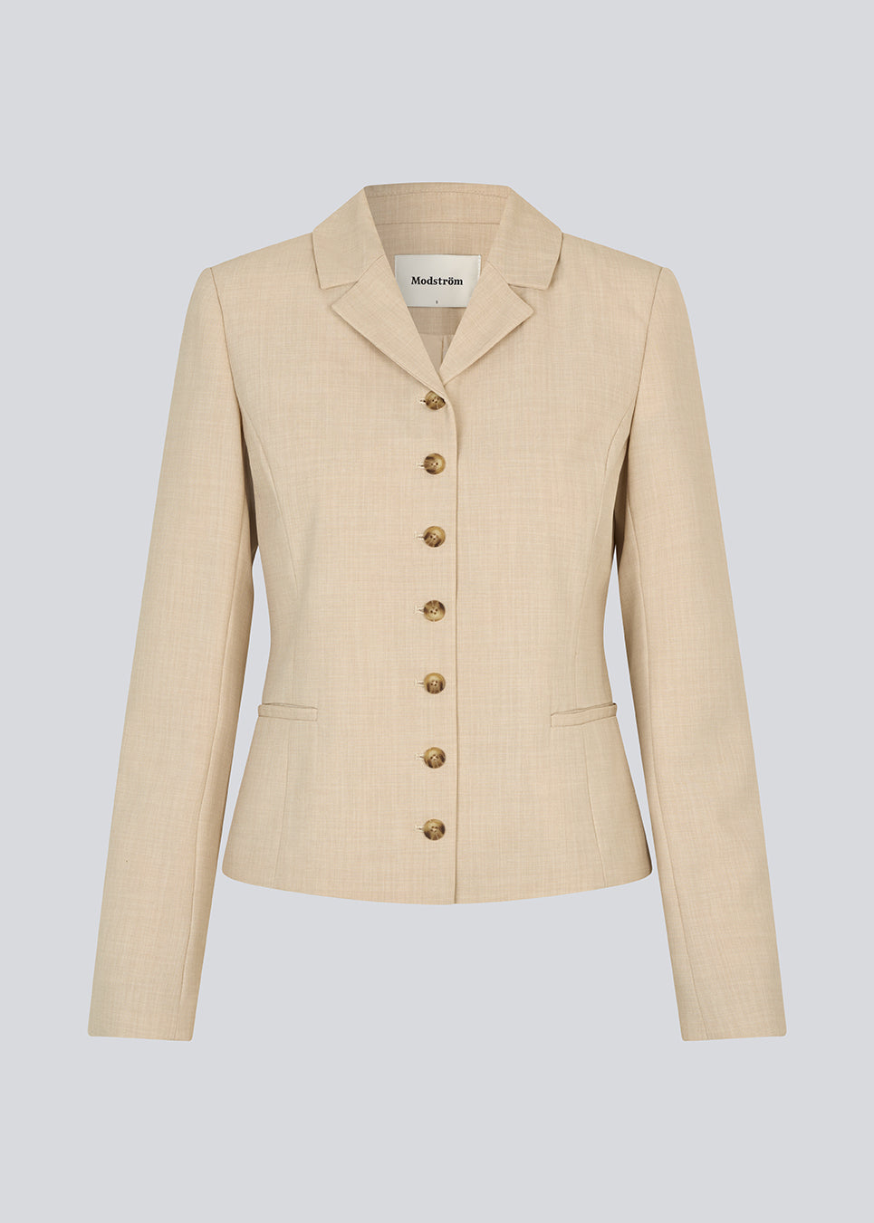 GaleMD 2 short blazer features the classic Gale design but in a lighter quality. The blazer is fitted, slightly cropped, and has a button closure and two pockets in front. The blazer is light cream.