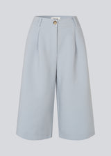 Long tailored shorts with pleats in classic Gale fabric. The GaleMD Long Shorts feature wide legs, side pockets, and fall just below the knee. Made from 76% recycled polyester, perfect for modern and stylish summer looks.