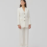 Gale blazer in white has a classic and elegant design, fulfilled by the beautiful revers collar and a long fit. The blazer has button closure at the front and a chest pocket at the left side.  Shop the look: Gale pants.