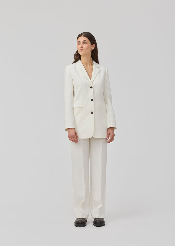 Gale blazer in white has a classic and elegant design, fulfilled by the beautiful revers collar and a long fit. The blazer has button closure at the front and a chest pocket at the left side.  Shop the look: Gale pants.